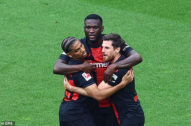 Victor Boniface (centre) scored Bayer Leverkusen's first goal as they beat Augsburg on Saturday to complete their unbeaten Bundesliga campaign.