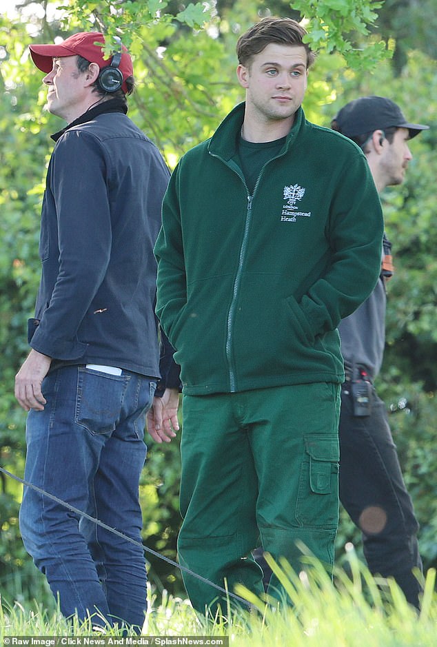 Leo Woodall, one of the stars of the hit series One Day, wears a green t-shirt and matching trousers - the uniform of the park keepers on Hampstead Heath.