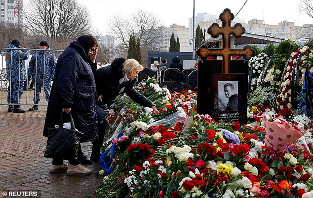 The mothers of Russian opposition leader Alexei Navalny and his widow Yulia Navalnaya, Lyudmila and Alla, in front of Navalny's grave on March 2, 2024, the day after his funeral at Moscow's Borisovskoye cemetery.