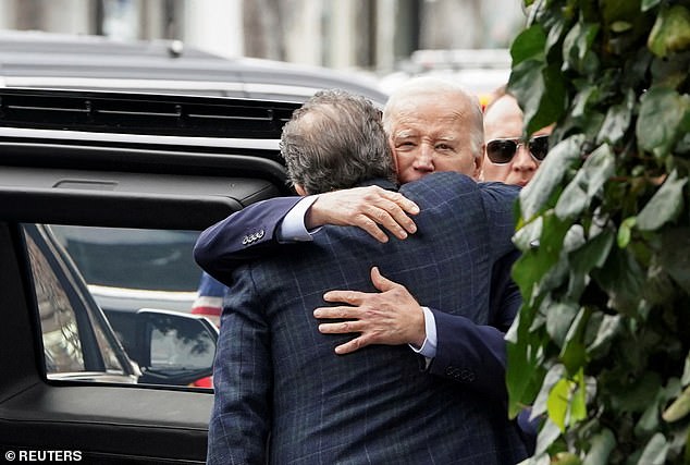 President Biden hugs his son Hunter after leaving a restaurant on Hunter's birthday in Los Angeles on February 4, 2024.