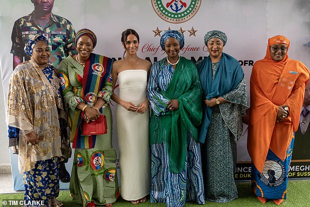 Meghan appears with five other dinner guests while attending a lunch with the Minister of Defense in Abuja, Nigeria.