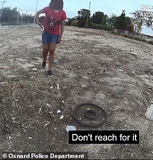 The officer in the video repeatedly orders the young woman to discard the knife.