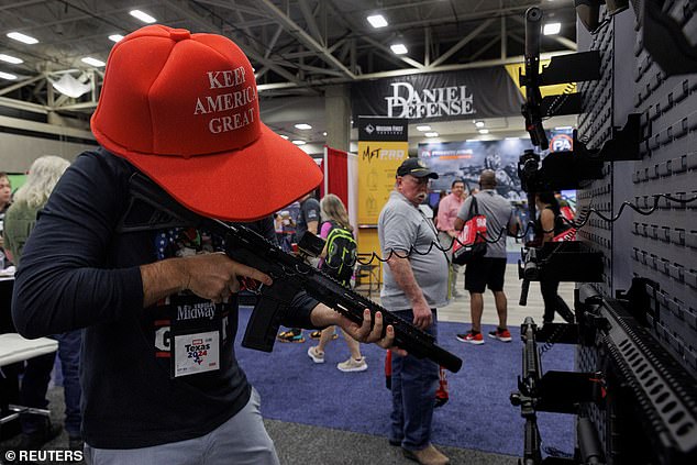 Danny Batsalkin holds a rifle during the annual meeting of the National Rifle Association (NRA) in Dallas, Texas, USA, May 18, 2024.