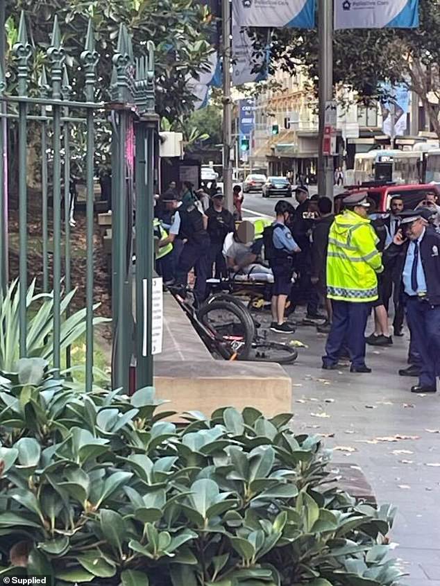 New South Wales Police confirmed that a 33-year-old man was arrested and taken to hospital for assessment (pictured, a man being treated at the scene)