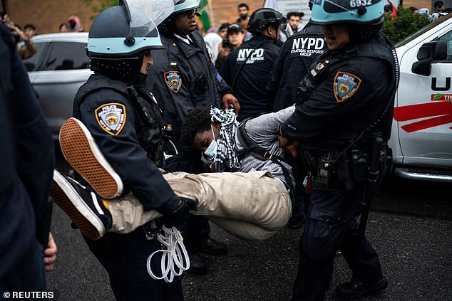 NYPD officers charge detained pro-Palestinian protester