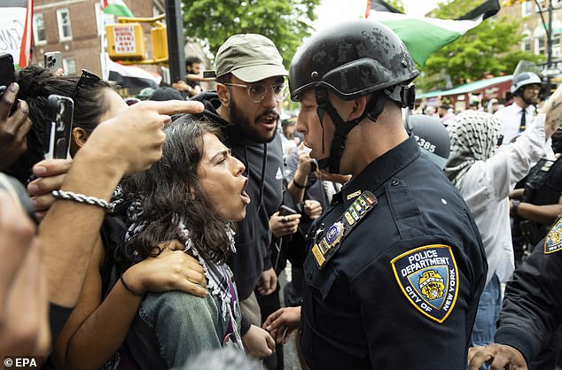 People argue with police officers during a pro-Palestine march, organized in part to observe a Nabka commemoration.