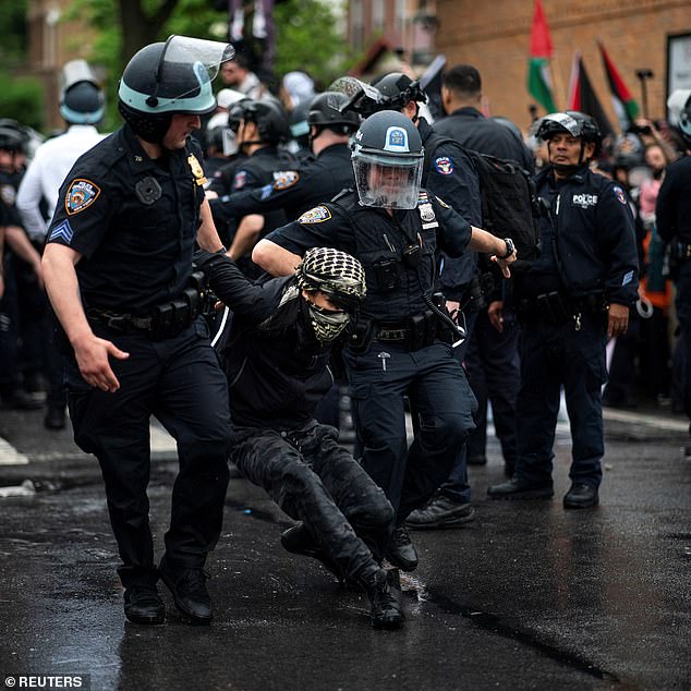 Footage shows officers tackling and dragging protesters away to arrest them as they continued to shout and fight back.