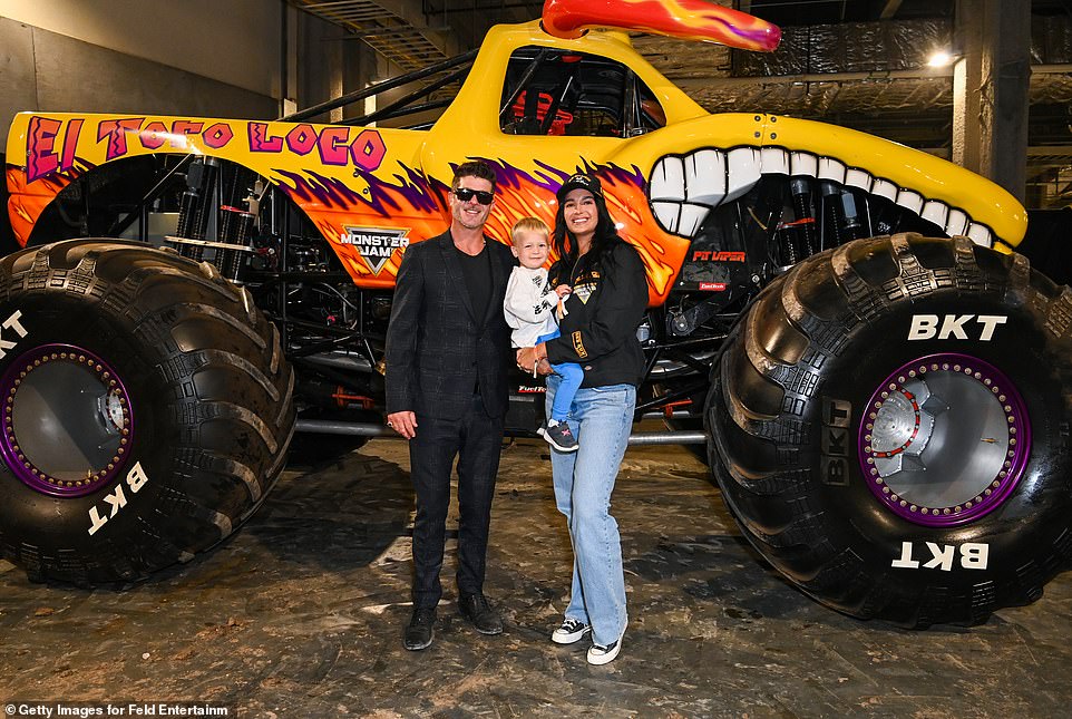 Robin Thicke flashed a wide smile as his fiancée, April Love Geary, held their three-year-old son Luca as they posed for a photo.