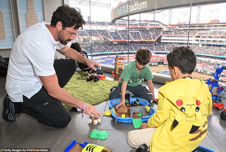 The father and son duo were also photographed playing with toy monster trucks during the event.