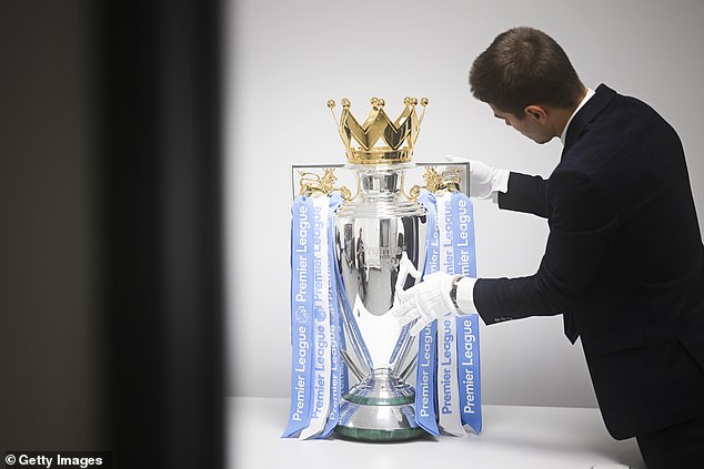 The Premier League trophy is seen with Manchester City ribbons after Guardiola's side beat West Ham 3-1