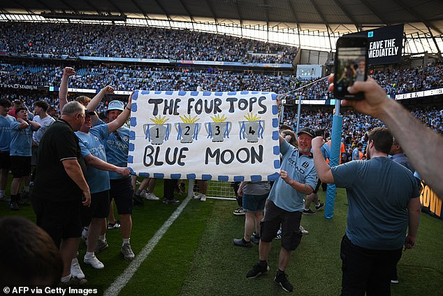 Manchester City fans invade the Etihad field after their team's historic victory in the Premier League.