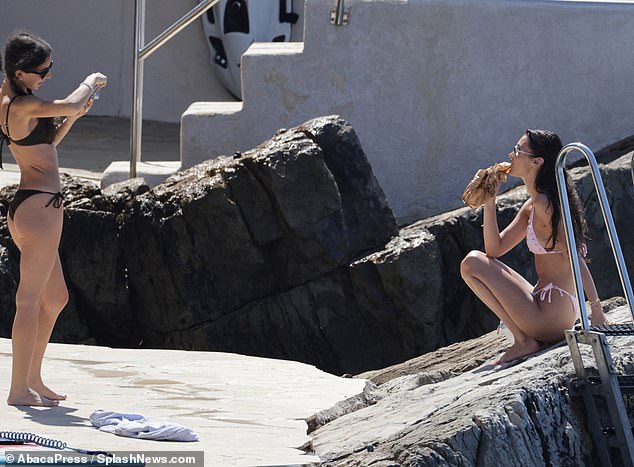 He sat on a rock while eating while his friend took photos of him.