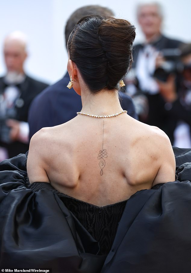 The actress, best known for her work in Bollywood, showed off her simple black tattoo on her spine.