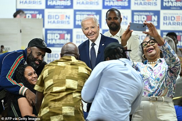 President Joe Biden poses for a photo Sunday during a campaign stop in Detroit, Michigan, at CRED Cafe. He had lighter contact with former President Donald Trump than in recent appearances.