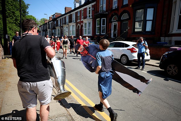 Some fans were seen carrying a replica of the Champions League and Klopp cutout at Anfield.