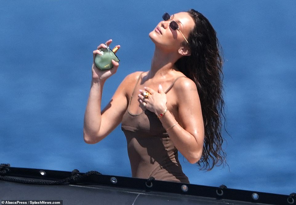 She posed for some sensual photos on the boat, showing off a bottle of her new Orebella perfume.