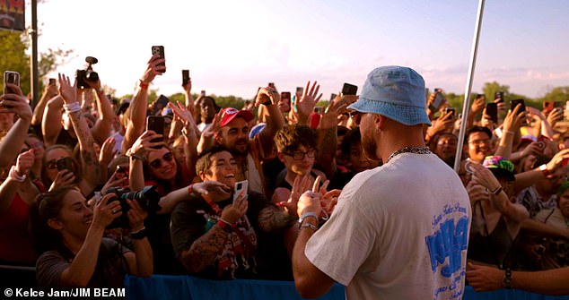 Kelce arrived at the festival wearing blue jeans and a bob hat while greeting fans before the show.