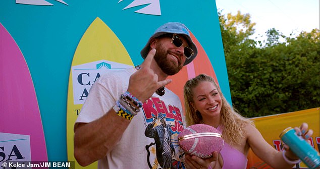 Kelce with a fan and revealed that Uncrustables sandwiches are his favorite game day snack.