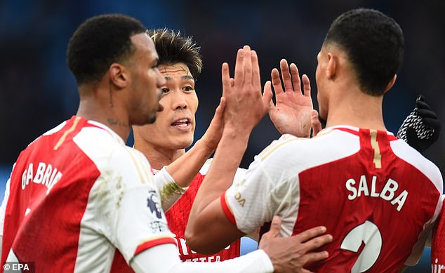 Arsenal celebrate after a goalless draw at the Etihad at the end of March