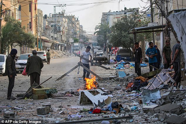 Palestinians recover items from the rubble of a family home that was hit overnight during an Israeli bombardment in the Tal al-Sultan neighborhood of Rafah, southern Gaza, May 20, 2024.