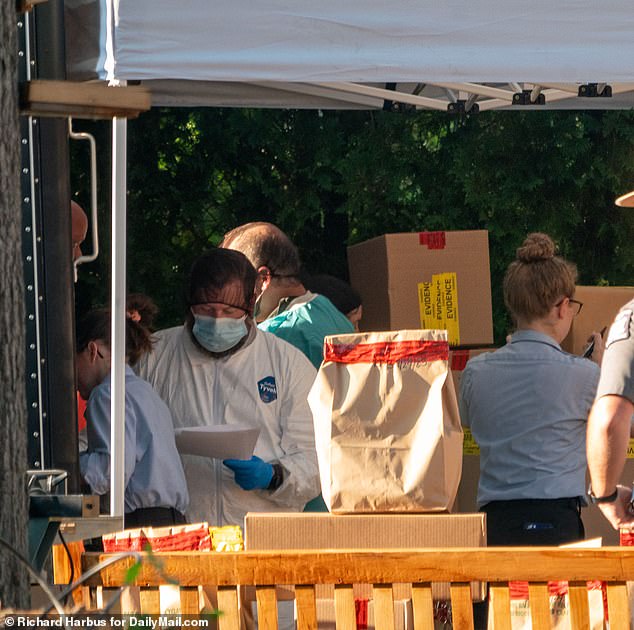 The Suffolk County District Attorney's Office declined to comment on the nature of the new search. Pictured: Investigators dressed in front of Heuermann's home last July.