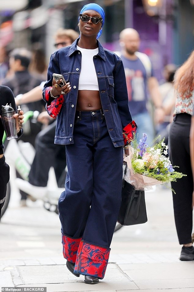 The Independent star carried her phone in one hand but in the other she held a bag containing a huge bouquet of flowers.