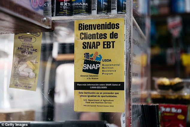 A sign alerting customers about SNAP food stamps is displayed at a Brooklyn grocery store.