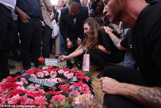 Footage from last night shows huge, brightly colored flower arrangements surrounded by hundreds of distraught mourners sobbing at the farewell service.