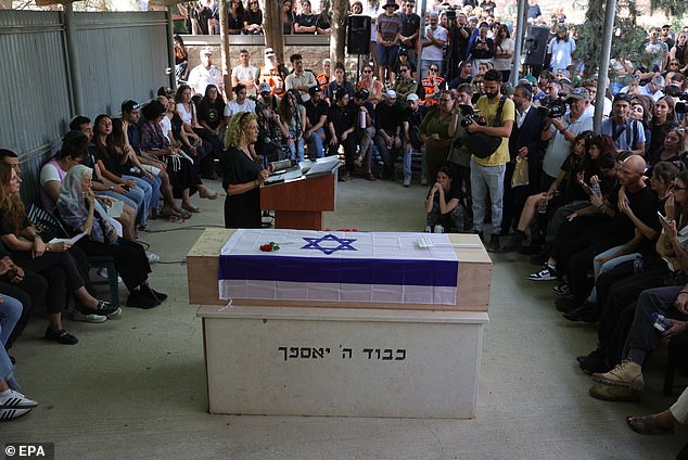 Friends and family attend the funeral of the Israeli-German hostage last night.