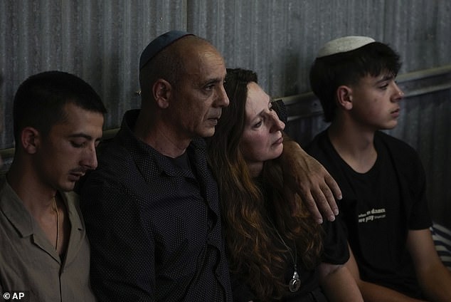 Shani Louk's parents mourn at her funeral in Srigim, Israel, on Sunday.