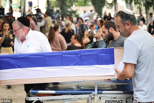 Relatives and friends carry the coffin during the funeral on Sunday