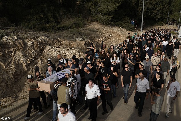 Mourners carry Shani Louk's flag-draped coffin during his funeral in Srigim, Israel.