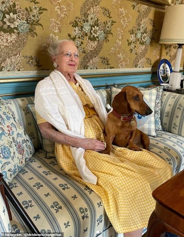 Queen Margaret was photographed with her dog Tillia sitting on her lap as she watched the royal race from Fredensborg Castle.