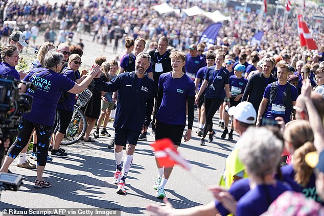 The monarch appeared to be in high spirits as he chatted with supporters at the starting line, high-fived spectators and gave interviews to the press.