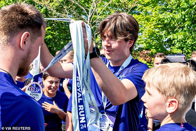 Pictured: Denmark's Crown Prince Christian presents medals during the Royal Run in Broenderslev.