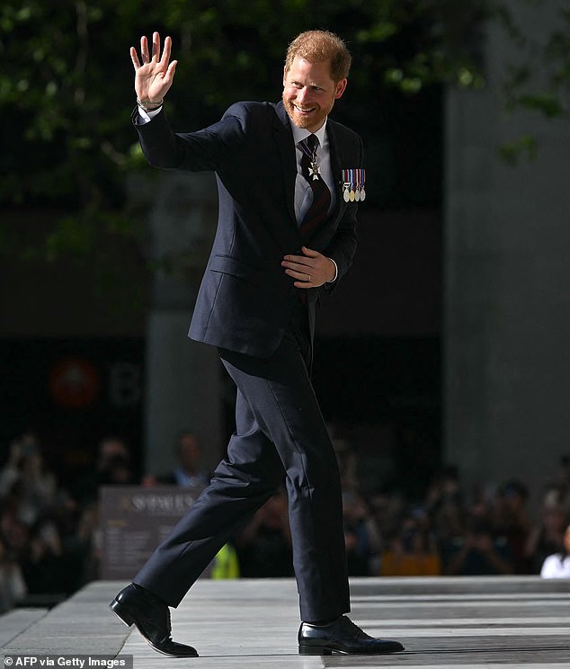 Prince Harry waves as he arrives to attend the ceremony at St Paul's Cathedral on May 8.