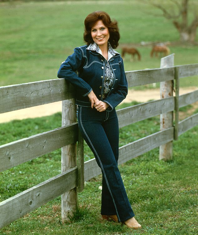 Loretta photographed in 1972 for a portrait wearing a blue denim suit.