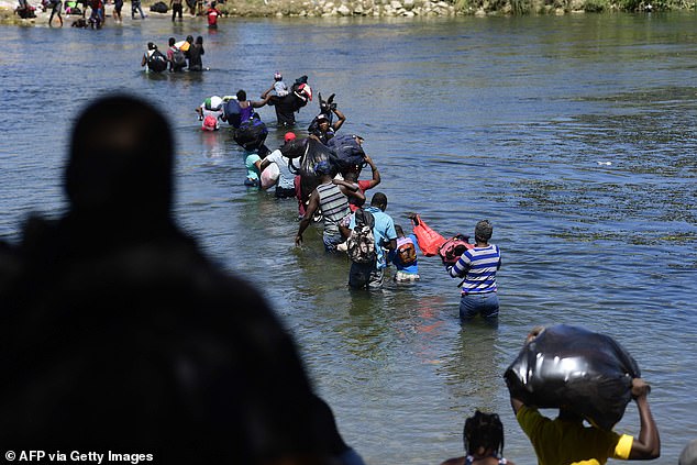 Haitian migrants cross the Rio Grande from Mexico into the US