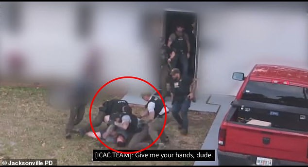 In a video he is seen being approached by at least six officers and a police dog.