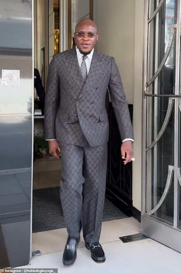 The cousin of Star Wars actor John Boyega donned a gray two-piece Gucci suit with matching tie as he led thousands of mostly black women down the street in support of the 