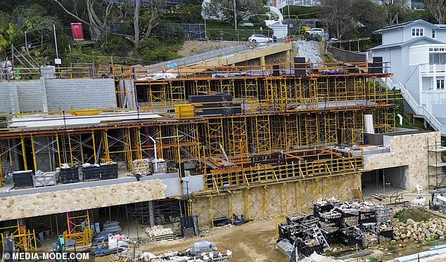 Scaffolding covered the facade of the mega-mansion, providing a safe passage for merchants to move around the skeleton of the multimillion-dollar home.