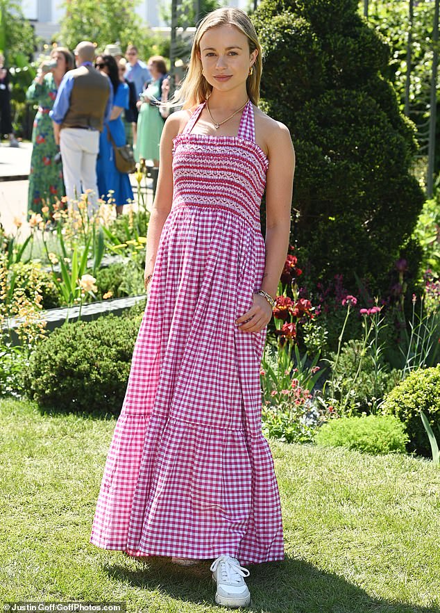 Pictured: Lady Amelia Windsor looked elegant in a red plaid dress and chunky white sneakers.