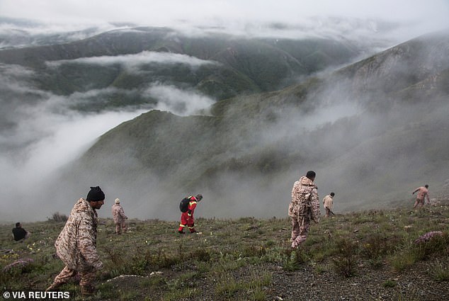 Rescue teams scour the mountains to find the crashed helicopter and its occupants.