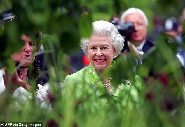 The Queen smiles as she is shown an exhibition at the Chelsea Flower Show in 2004.