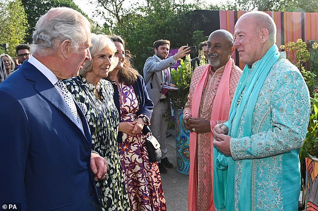 King Charles and Queen Camilla speak to a couple who married at the Eastern Eye Garde of Unity during the Chelsea Flower Show in 2023.