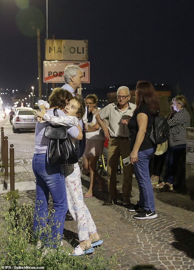 Concerned citizens gather in a safe area along the seafront between Naples and Pozzuoli following an overnight earthquake