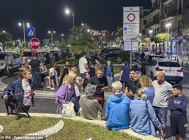 Concerned citizens gather in a safe area along the seafront between Naples and Pozzuoli following an overnight earthquake