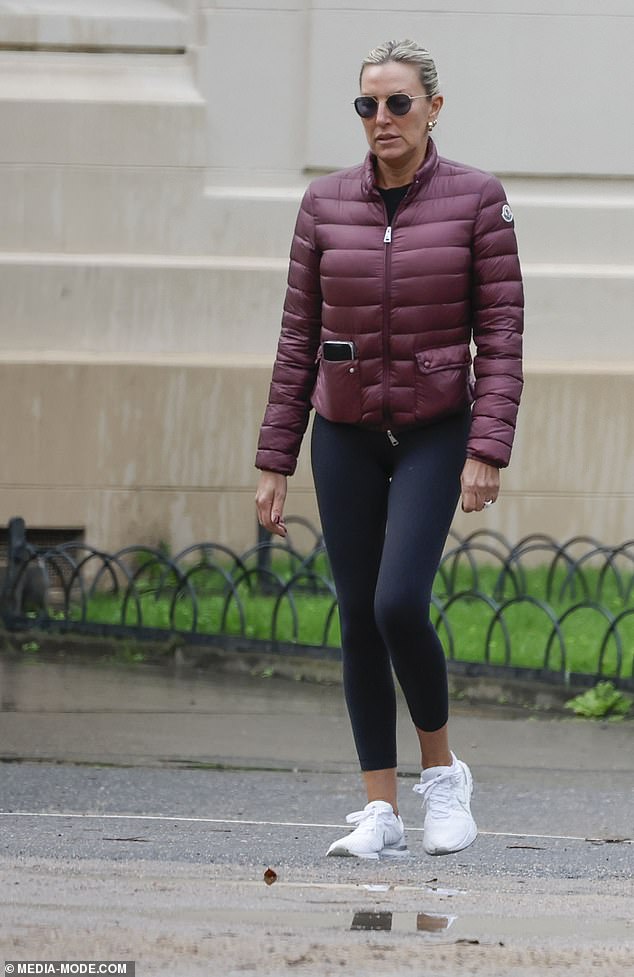 She dressed warmly against the cold weather in a maroon puffer jacket over a black shirt.