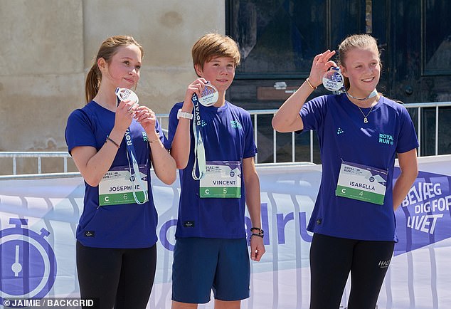 Twins Princess Josephine and Prince Vincent, 13, and their older sister Princess Elizabeth, 15, hold their medals at the end of the Royal Run.