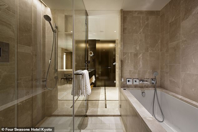 The marble-clad bathroom in a Premier room has a walk-in shower and a deep soaking tub.